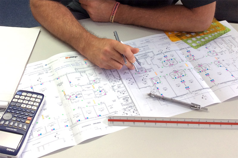 Technician working on data network design plans